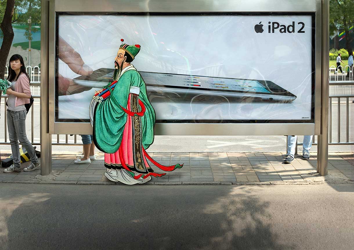 Confucius walking past modern ipad ad